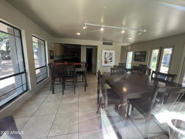 5203 N 24th St Unit 207, Phoenix, AZ 85016 - dining space with plenty of natural light, rail lighting, and light tile patterned floors