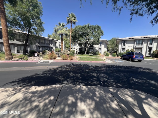 5203 N 24th St Unit 207, Phoenix, AZ 85016 - view of asphalt road with a residential view, curbs, sidewalks, and traffic signs