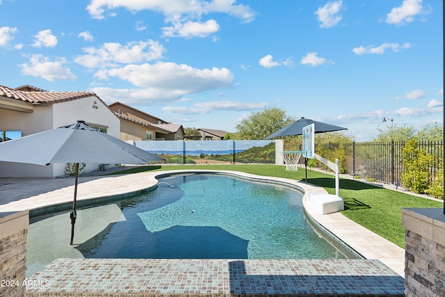 view of pool featuring a lawn and a patio area