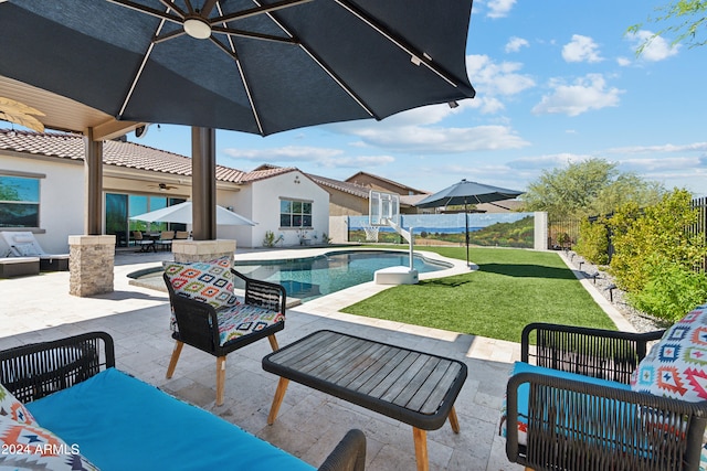 view of patio / terrace featuring ceiling fan, a fenced in pool, and an outdoor hangout area