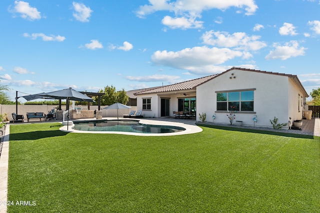 back of property featuring a fenced in pool, a patio, and a yard