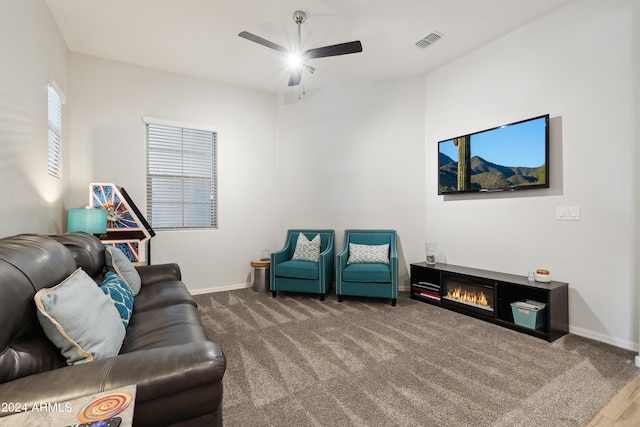 carpeted living room with ceiling fan