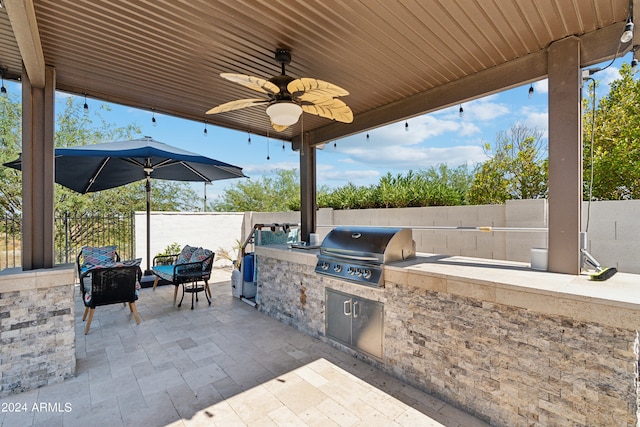 view of patio with ceiling fan and area for grilling