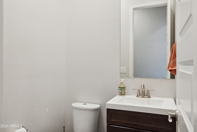 bathroom with toilet and vanity