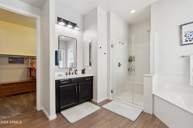 bathroom with tile patterned flooring, independent shower and bath, and vanity