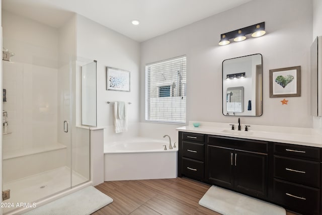 bathroom featuring independent shower and bath and vanity