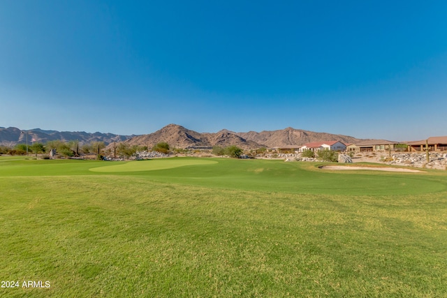 view of community featuring a mountain view and a yard