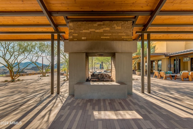 wooden terrace featuring a mountain view and a multi sided fireplace