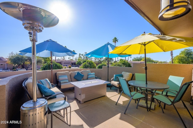 view of patio with an outdoor living space and a balcony