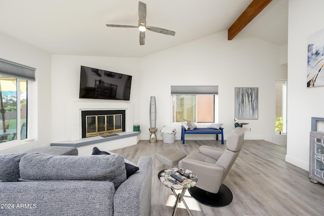 living room with vaulted ceiling with beams, ceiling fan, plenty of natural light, and hardwood / wood-style flooring