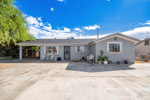 ranch-style house featuring a patio area and a carport