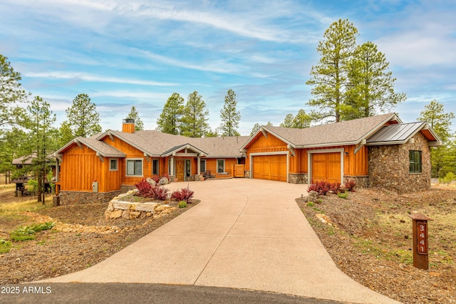 3441 S Del Aire Ct Unit 182, Flagstaff, AZ 86005 - view of front of home with board and batten siding, an attached garage, stone siding, and driveway
