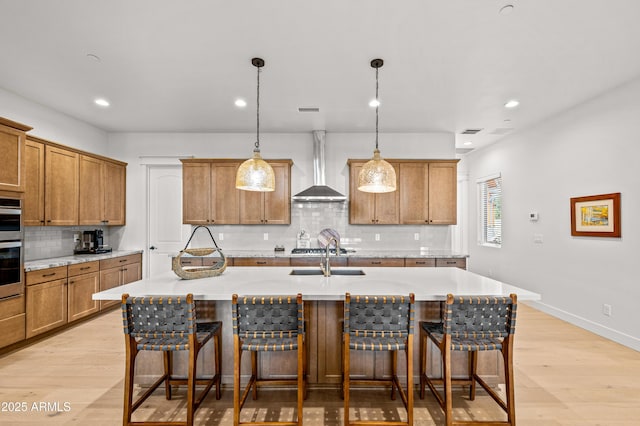 3441 S Del Aire Ct Unit 182, Flagstaff, AZ 86005 - kitchen featuring wall chimney exhaust hood, brown cabinets, a sink, tasteful backsplash, and recessed lighting