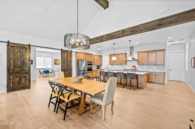 3441 S Del Aire Ct Unit 182, Flagstaff, AZ 86005 - dining space with a barn door, beamed ceiling, light wood-style floors, a chandelier, and recessed lighting