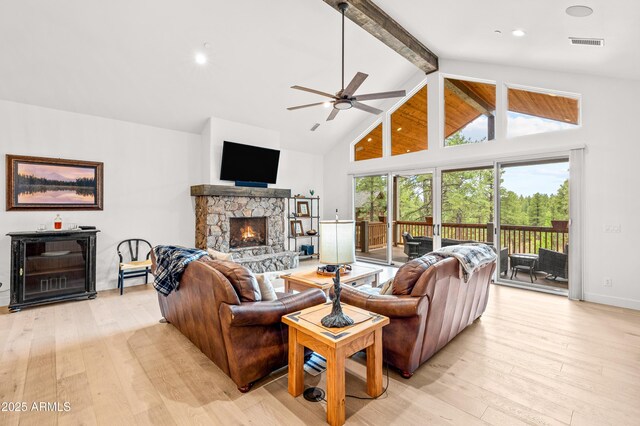 3441 S Del Aire Ct Unit 182, Flagstaff, AZ 86005 - living room featuring light wood-type flooring, beam ceiling, high vaulted ceiling, ceiling fan, and a stone fireplace