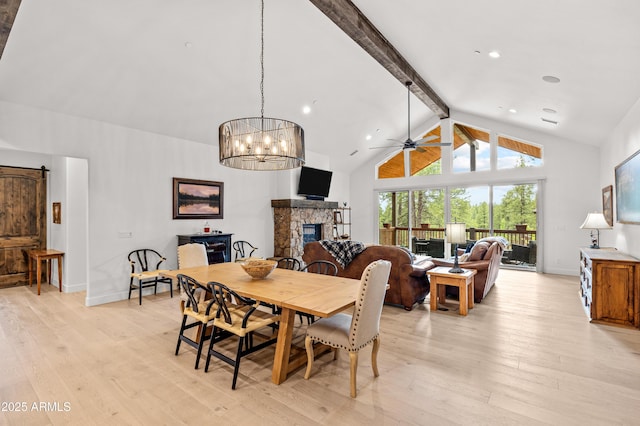 3441 S Del Aire Ct Unit 182, Flagstaff, AZ 86005 - dining room featuring beam ceiling, light wood-type flooring, a fireplace, high vaulted ceiling, and baseboards
