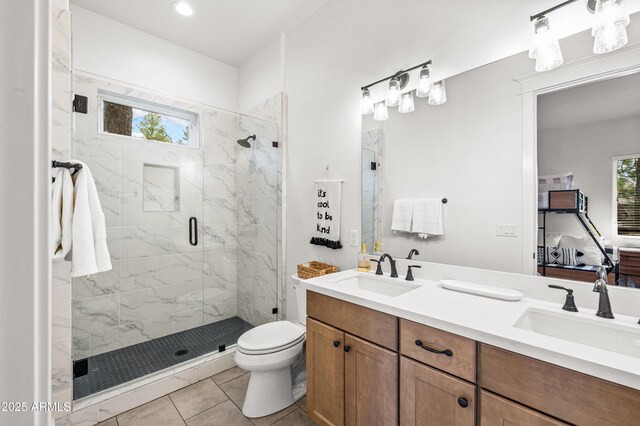 3441 S Del Aire Ct Unit 182, Flagstaff, AZ 86005 - full bathroom with a shower stall, double vanity, tile patterned floors, toilet, and connected bathroom