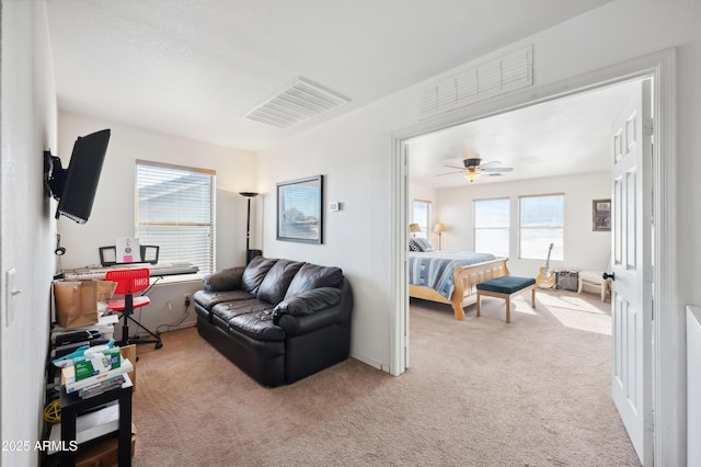 bedroom with ceiling fan and light colored carpet