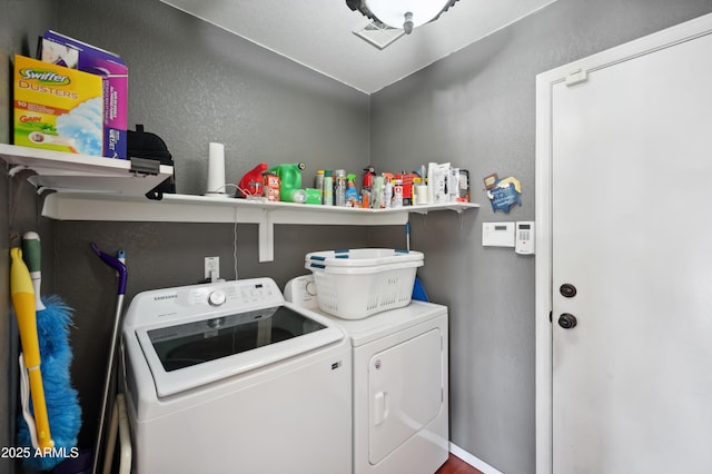 laundry area with washing machine and clothes dryer