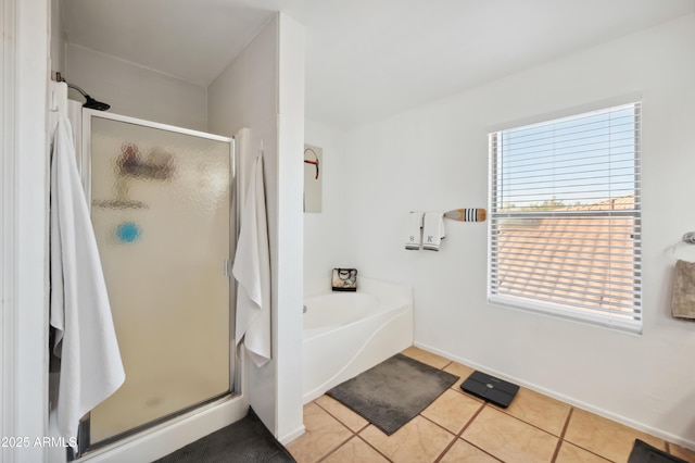 bathroom with independent shower and bath and tile patterned flooring