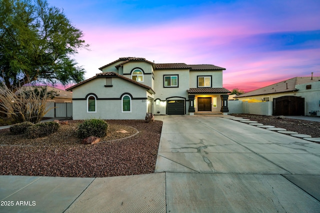 mediterranean / spanish-style home with a garage