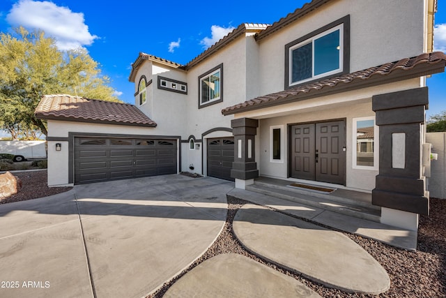 mediterranean / spanish-style home with a garage