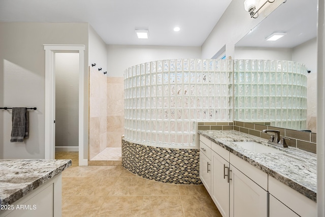 bathroom featuring tile patterned floors, vanity, and walk in shower