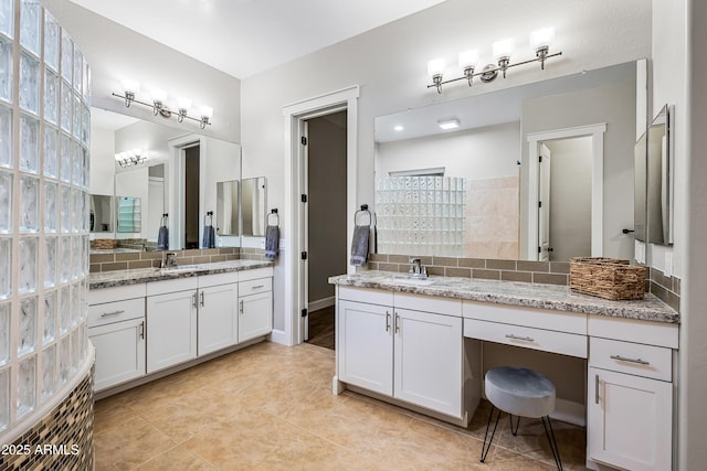 bathroom with vanity, tile patterned floors, and backsplash