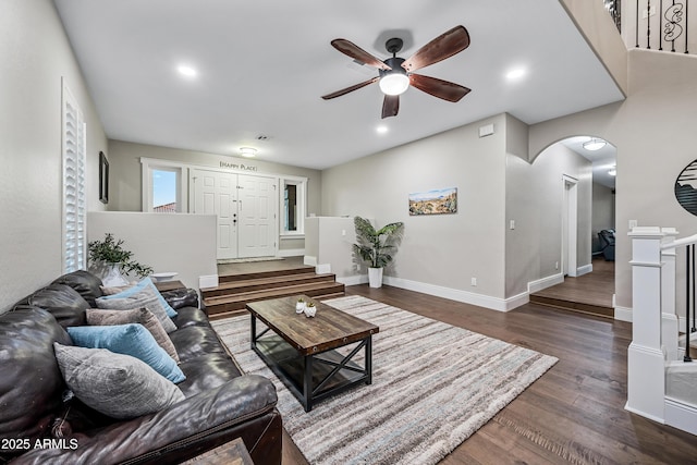 living room featuring dark hardwood / wood-style flooring and ceiling fan