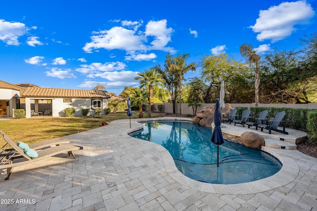 view of pool with a yard and a patio