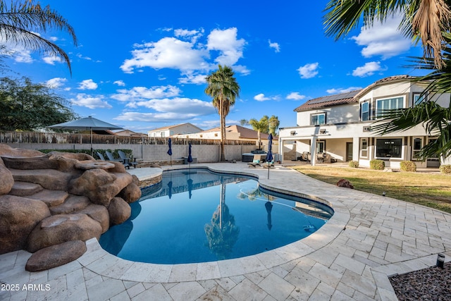 view of pool featuring a yard and a patio