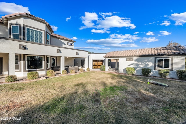 back of house with outdoor lounge area and a lawn