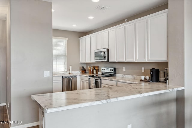 2237 S Jacana Ln, Gilbert, AZ 85295 - kitchen featuring stainless steel appliances, a peninsula, recessed lighting, white cabinets, and light stone counters