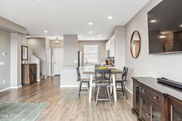 2237 S Jacana Ln, Gilbert, AZ 85295 - dining room with baseboards, light wood-style floors, and recessed lighting