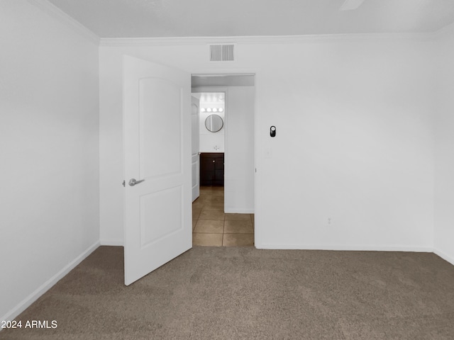 empty room with carpet floors and crown molding