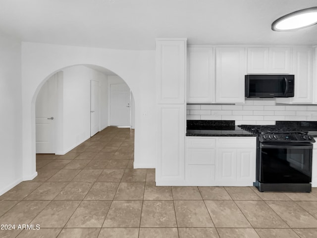 kitchen with light tile patterned floors, black appliances, white cabinetry, and tasteful backsplash