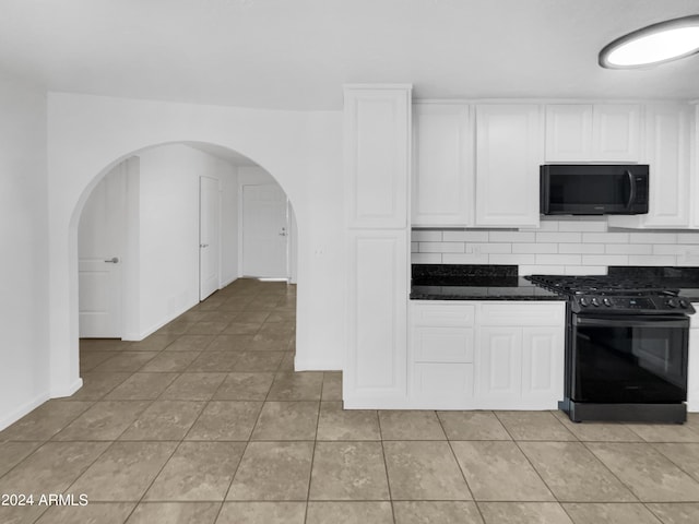 kitchen with tasteful backsplash, white cabinetry, light tile patterned floors, and black appliances