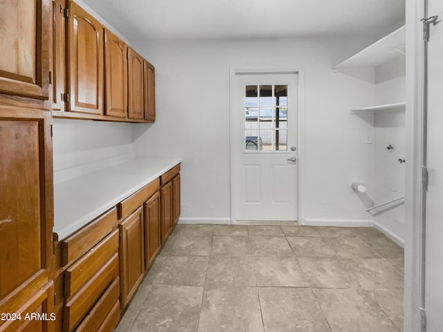 laundry room with cabinets and light tile patterned floors