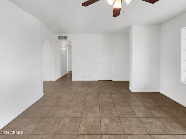 unfurnished room with tile patterned floors and ceiling fan