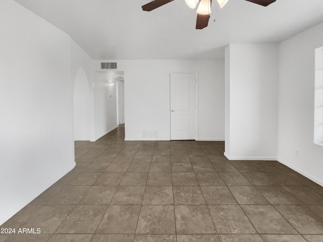 unfurnished room featuring tile patterned floors and ceiling fan