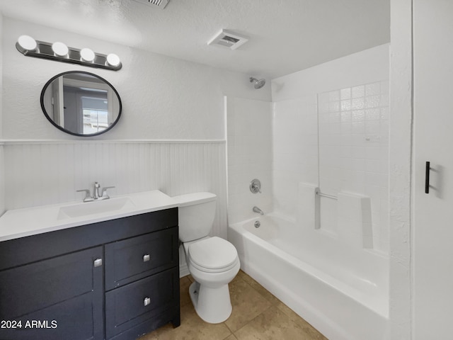 full bathroom featuring tile patterned flooring, shower / washtub combination, a textured ceiling, toilet, and vanity