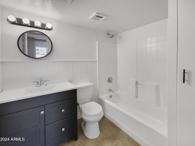 full bathroom featuring bathtub / shower combination, tile patterned flooring, vanity, toilet, and a textured ceiling