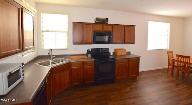 kitchen with sink, black appliances, and dark hardwood / wood-style floors