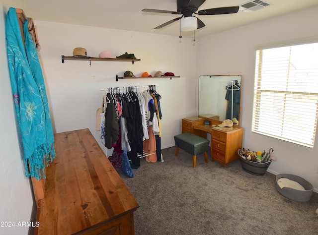 walk in closet with ceiling fan and carpet floors