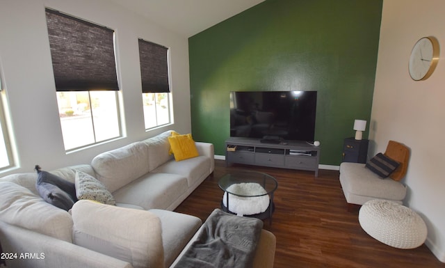 living room with dark wood-type flooring and vaulted ceiling