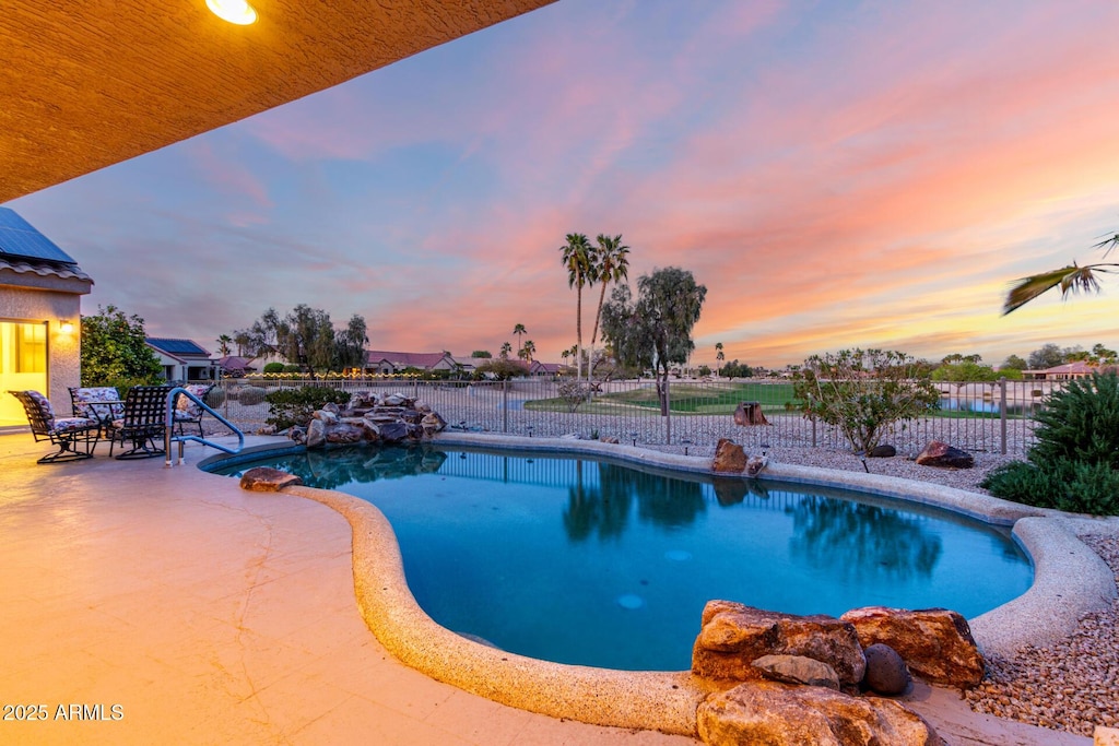 19793 N Tapestry Ct, Surprise, AZ 85374 - pool at dusk with a fenced in pool, a patio area, and fence