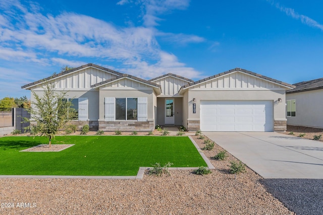 craftsman inspired home with a garage and a front lawn