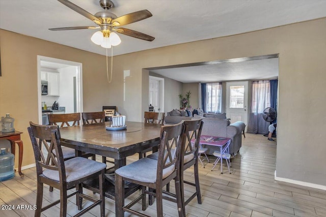 dining space featuring ceiling fan and hardwood / wood-style flooring