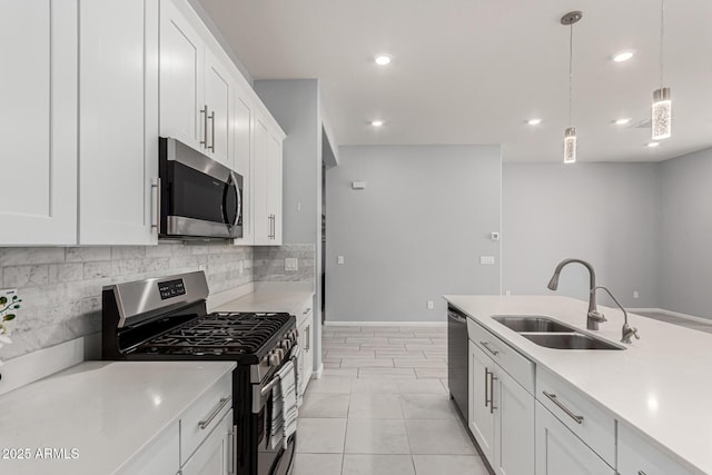 kitchen with appliances with stainless steel finishes, a sink, light countertops, recessed lighting, and backsplash