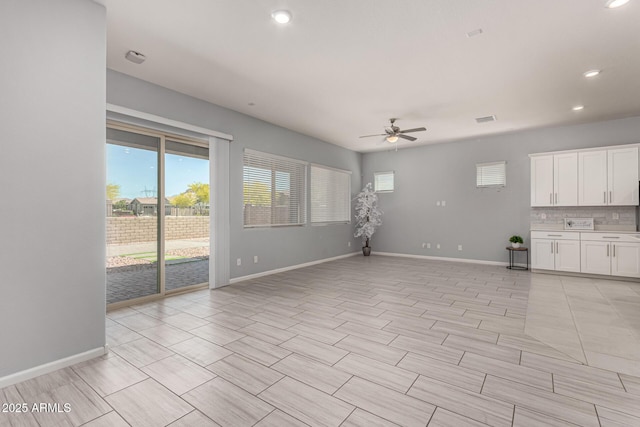 unfurnished living room featuring baseboards, a ceiling fan, recessed lighting, and visible vents